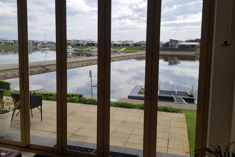 A View of a Lake Through a Sliding Glass Window — PJ Tinting In Port Macquarie, NSW