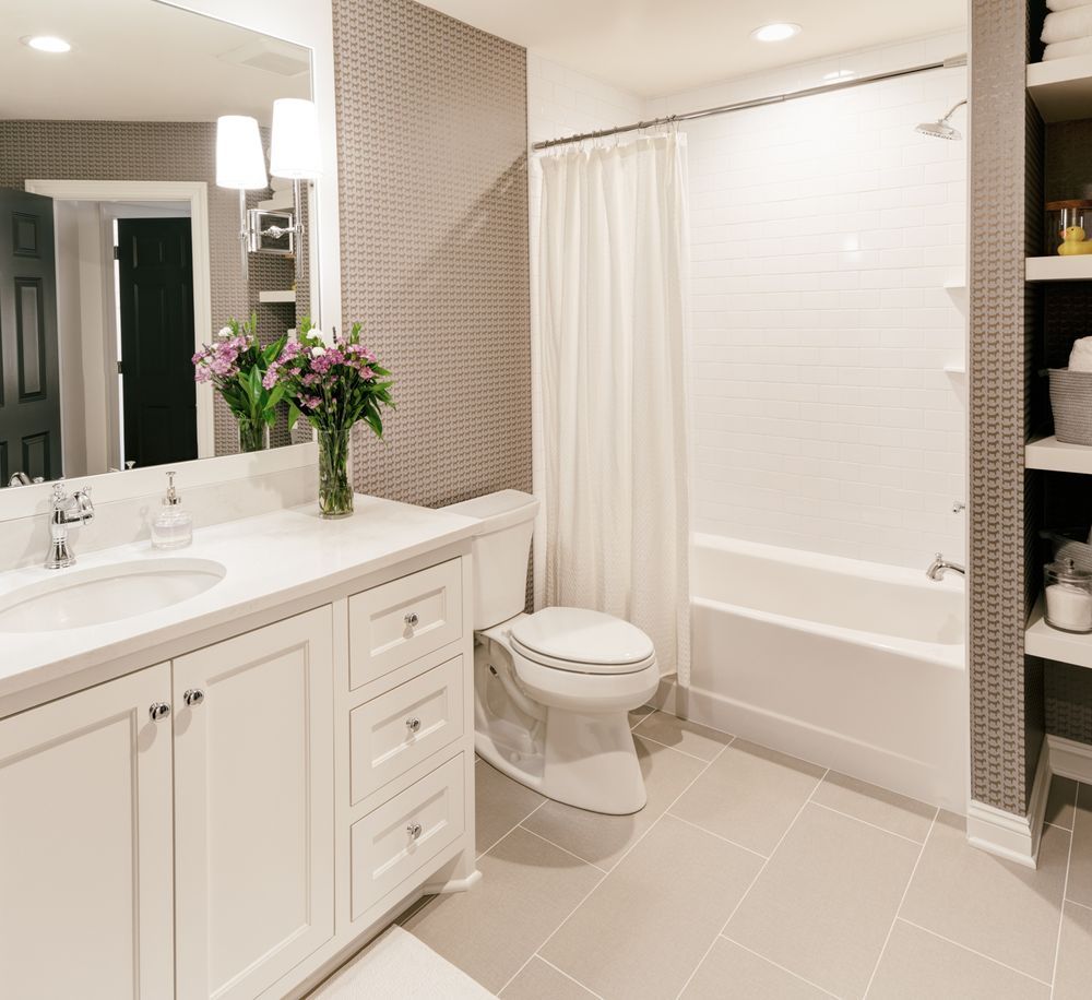A bathroom with a toilet a sink and a bathtub