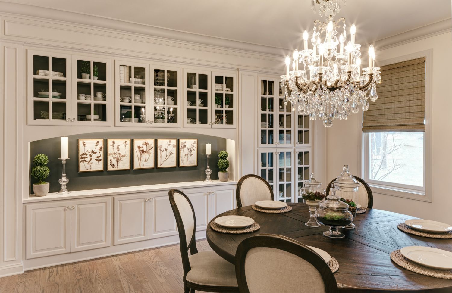 A dining room with a table and chairs and a chandelier.