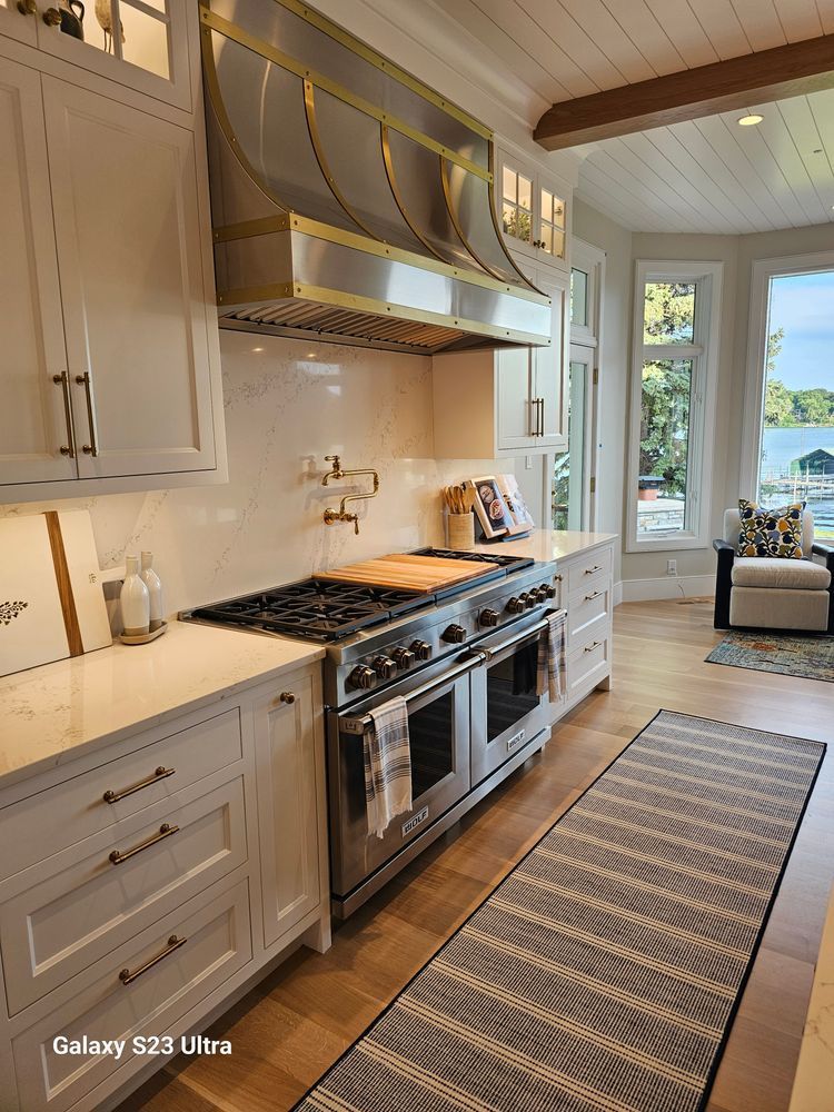 A kitchen with a stove , oven , and rug.