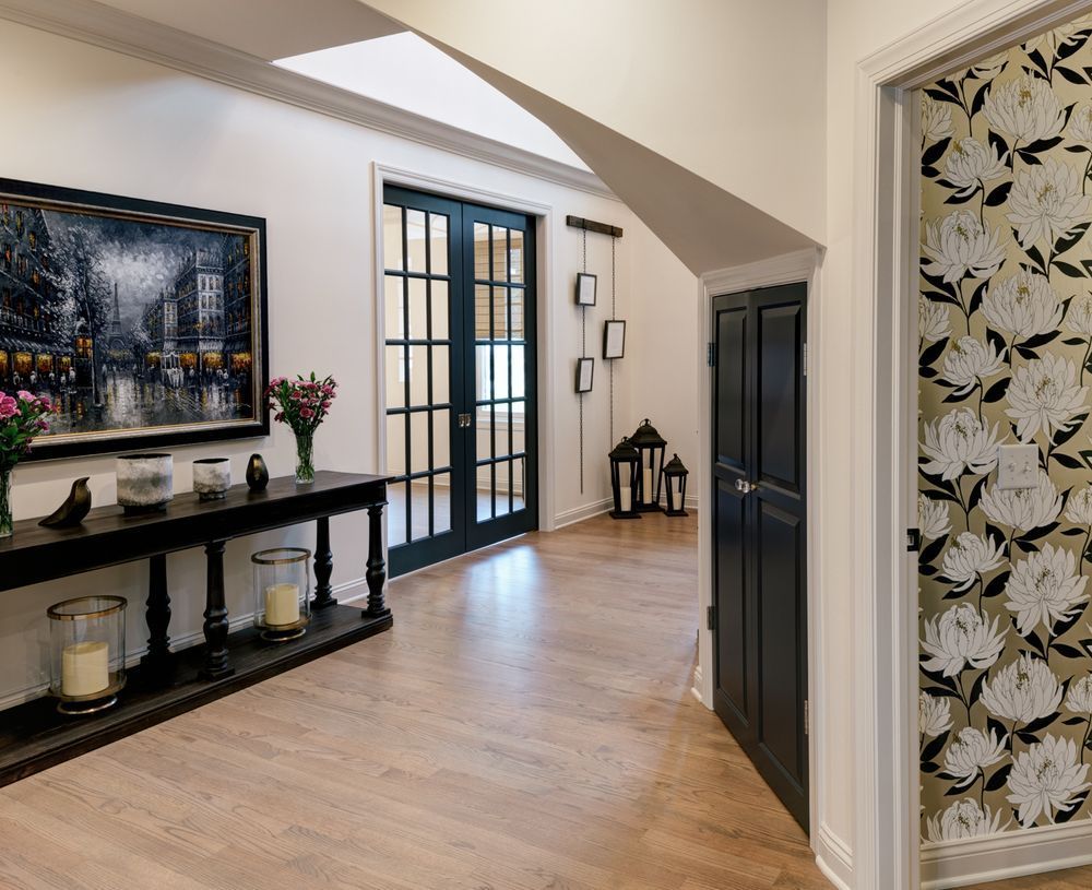A hallway with a table and a painting on the wall