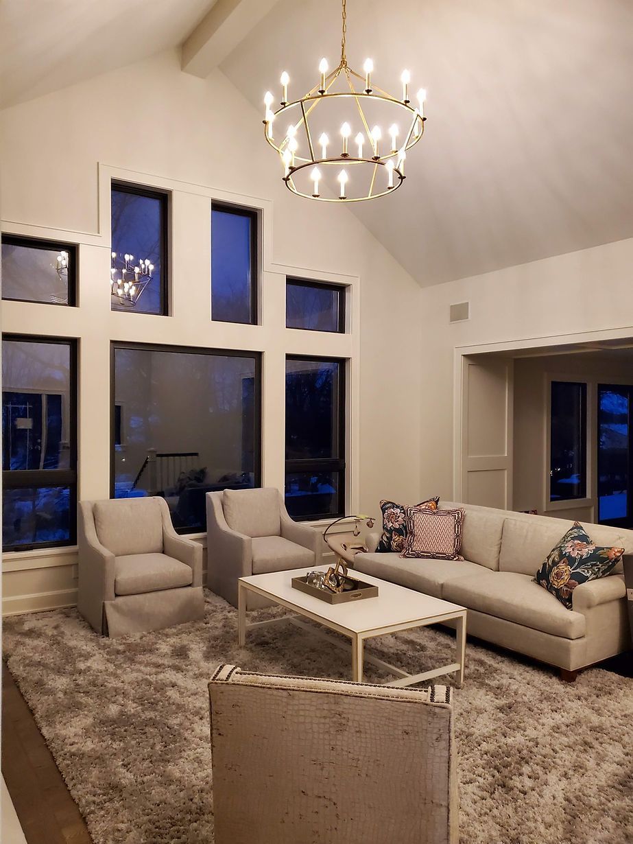 A living room filled with furniture and a chandelier.