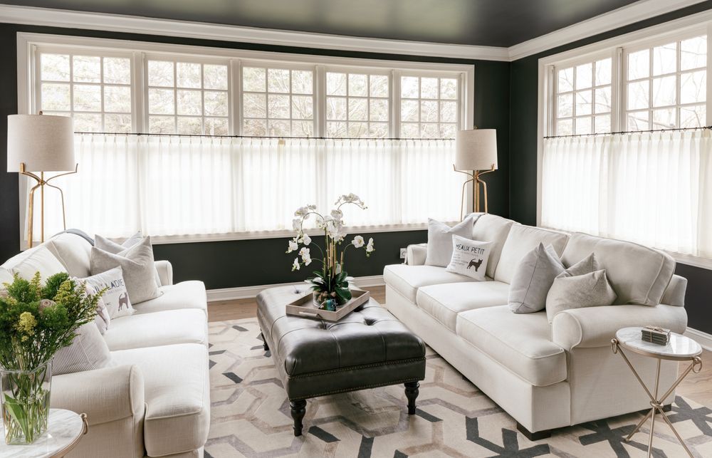 A living room with two couches , a coffee table , and a black ceiling.