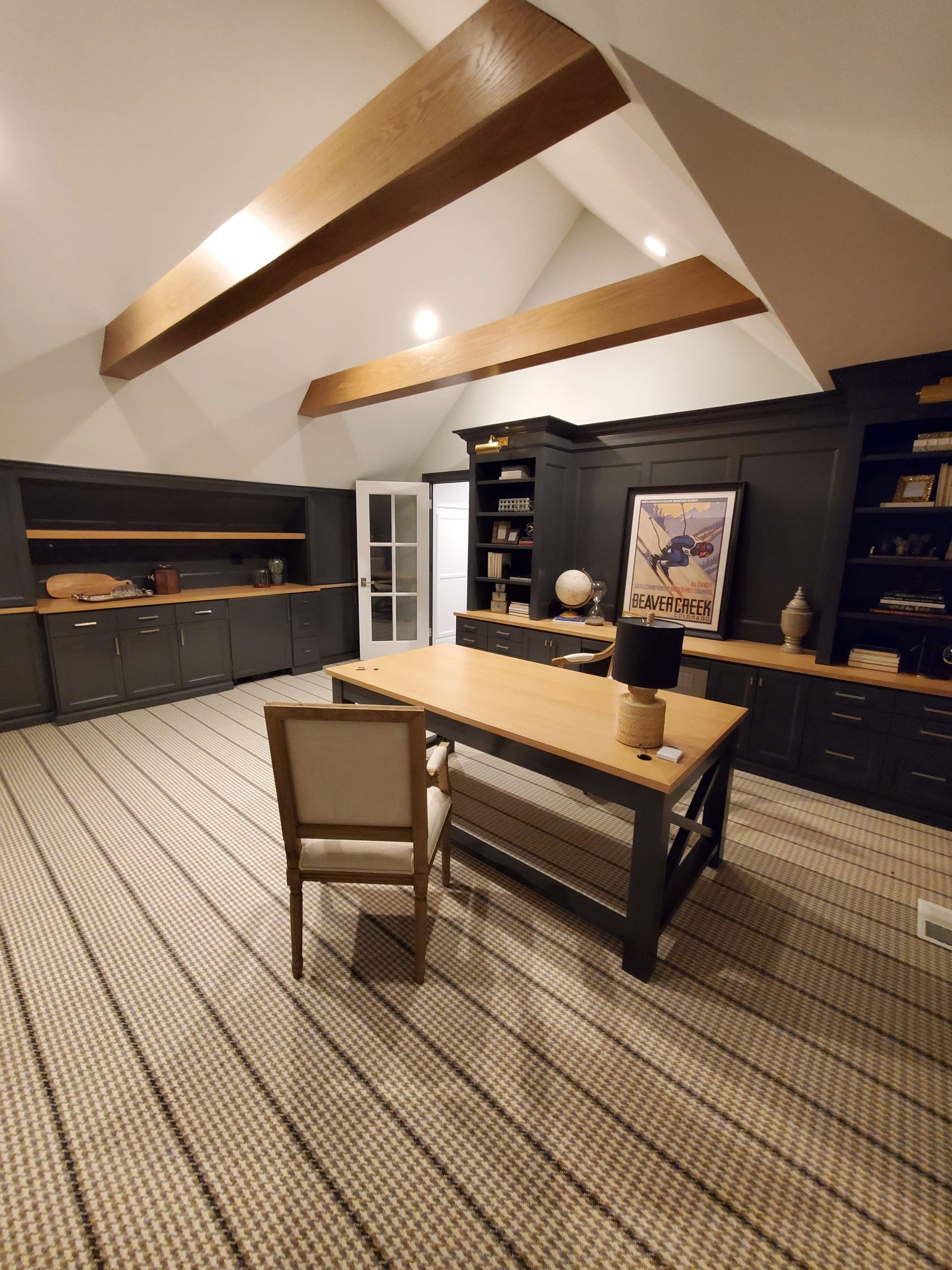 There is a desk and chair in the middle of the room.