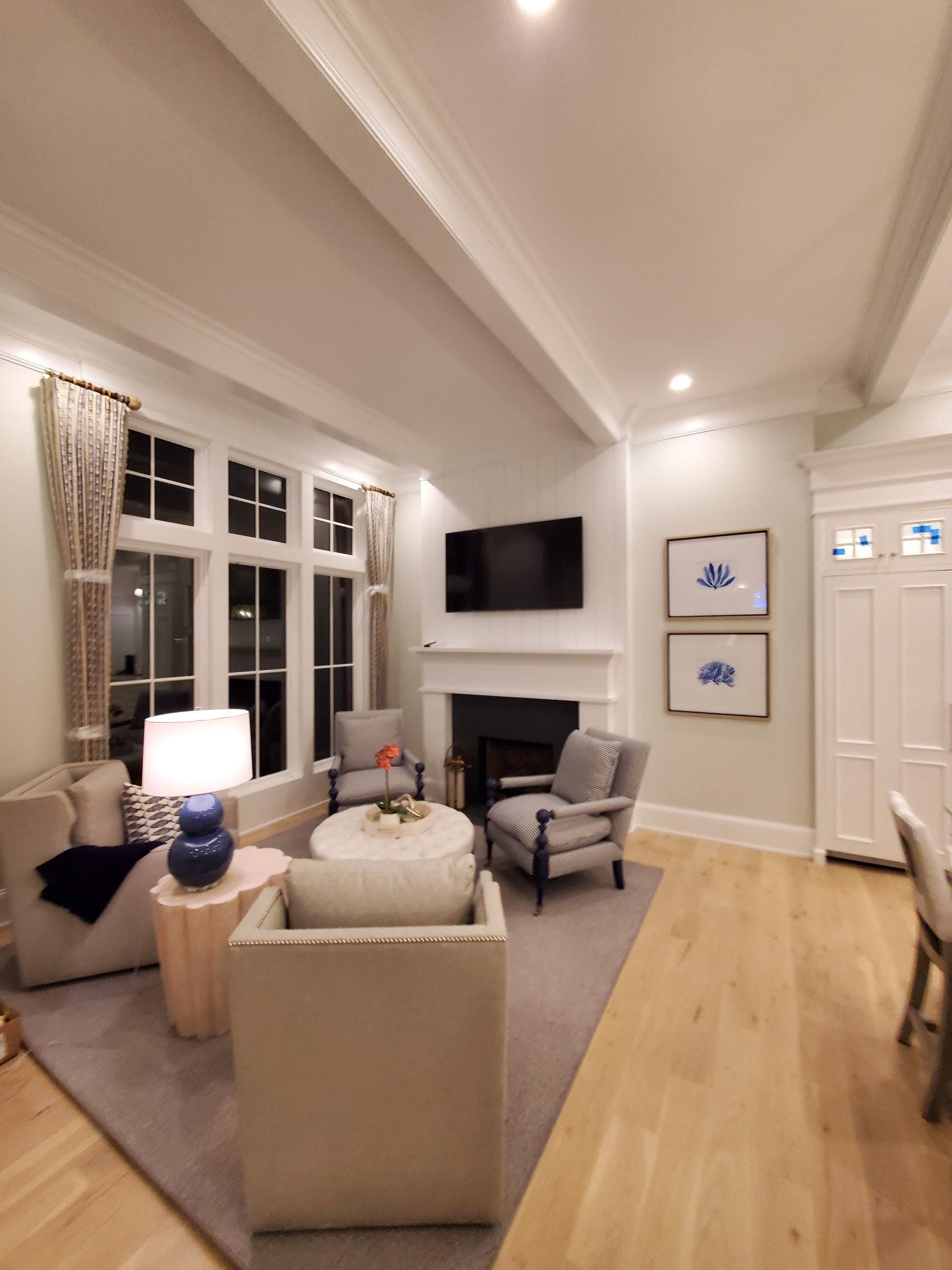 A living room with a fireplace and a flat screen tv