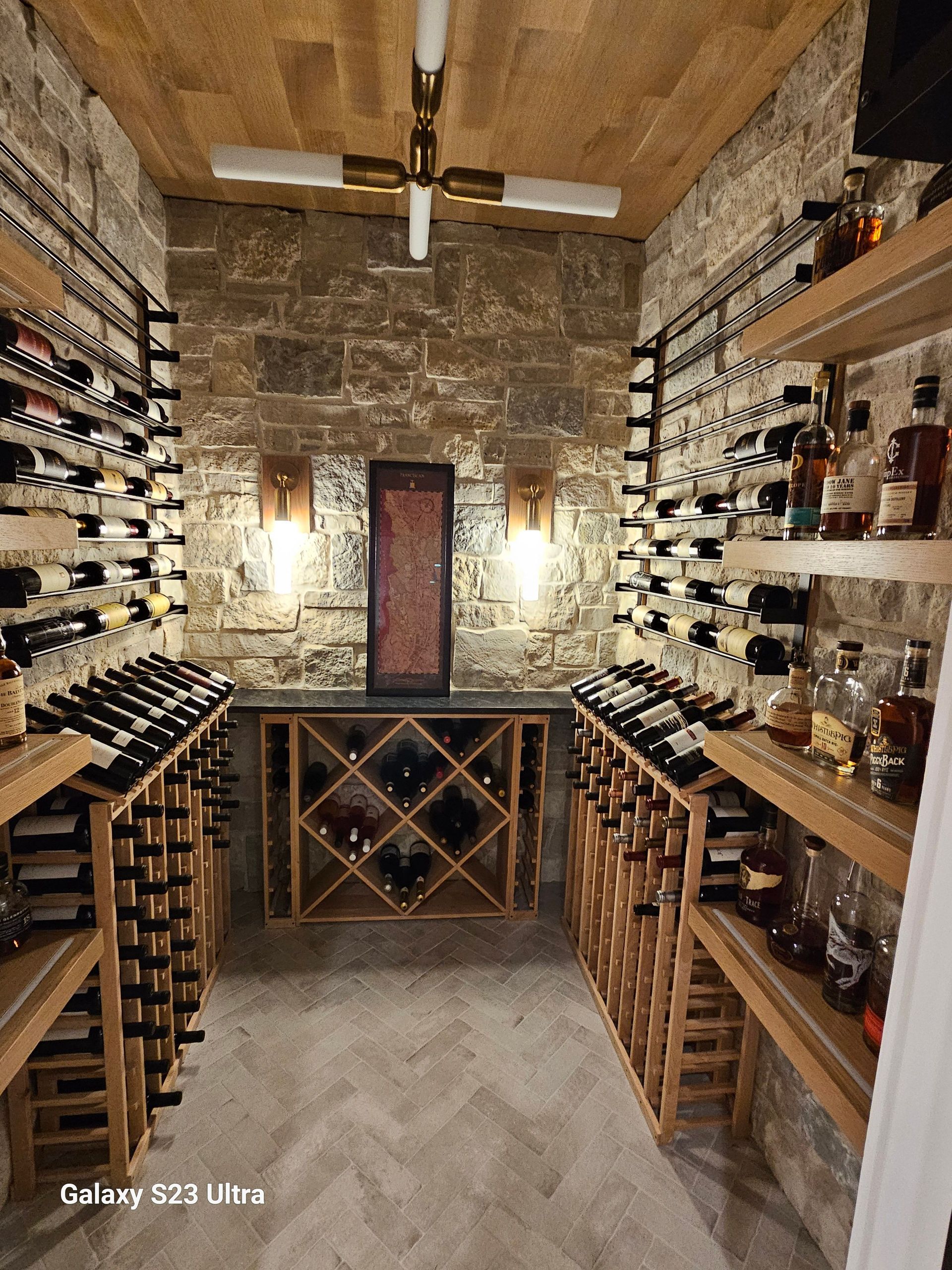A wine cellar filled with lots of bottles of wine and liquor.