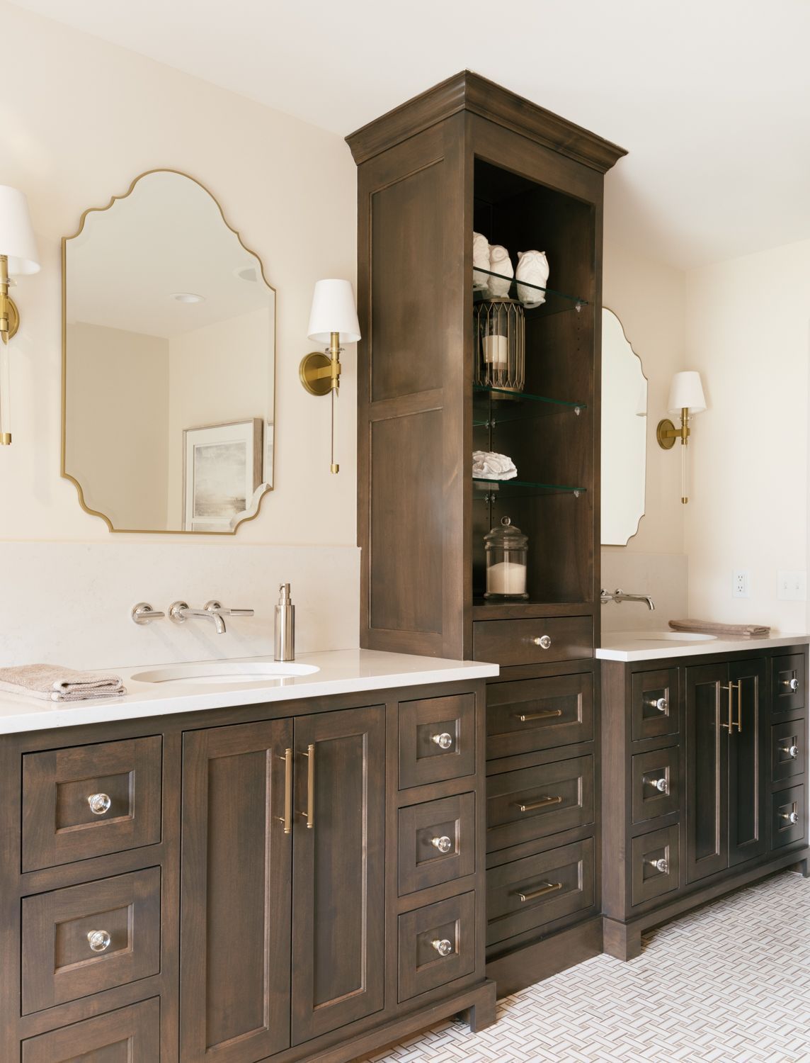 A bathroom with two sinks and a large mirror