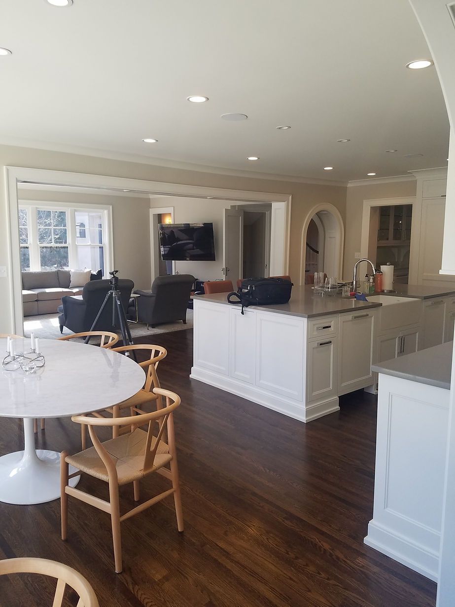 There is a table and chairs in the middle of the room.