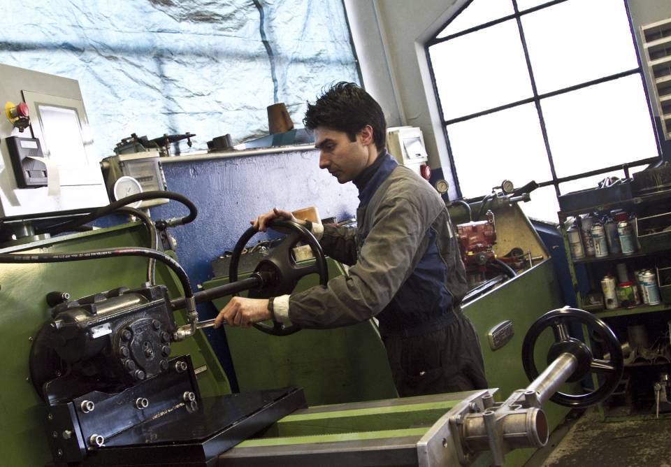 mechanic adjusting steering of industrial vehicle