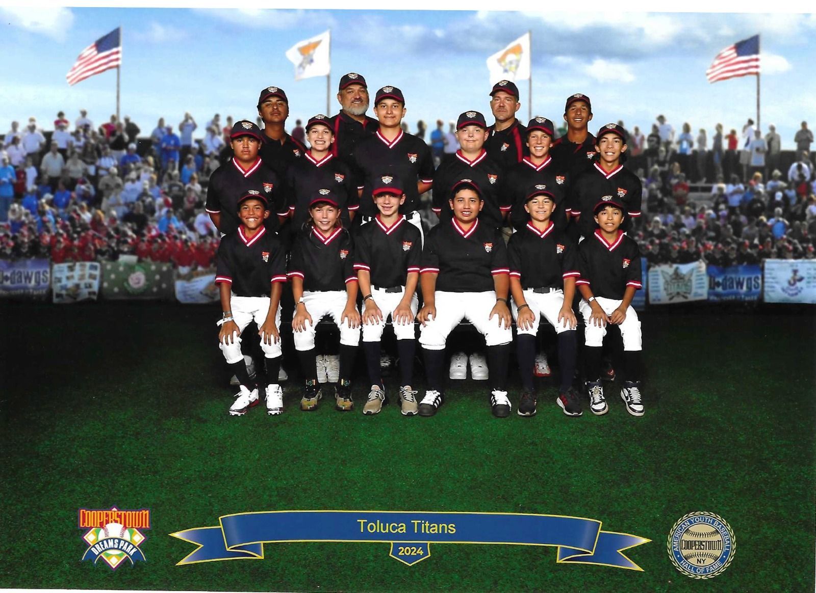 Baseball team, Toluca Twins, posing for a group photo on a field. Uniforms are black and red with white pants.