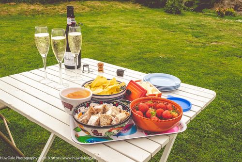 Table in a garden with champagne strawberries 