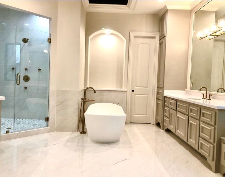 Luxury bathroom with a standalone tub, glass shower, and vanity. 