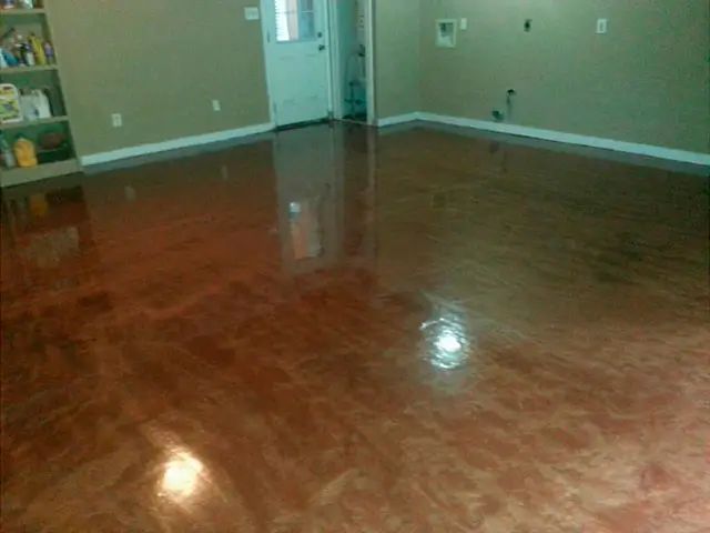 Shiny, metallic-looking red-brown epoxy floor reflecting the room's features.