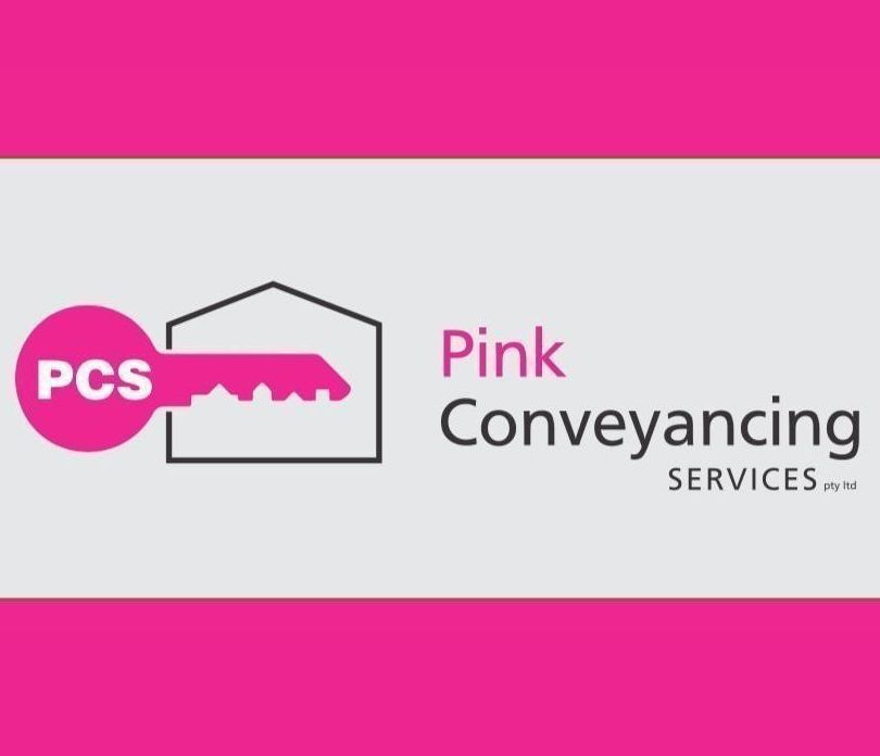 A Conveyancer in A Suit Is Sitting at A Table with A Woman and A Man — Pink Conveyancing Services in Port Macquarie, NSW