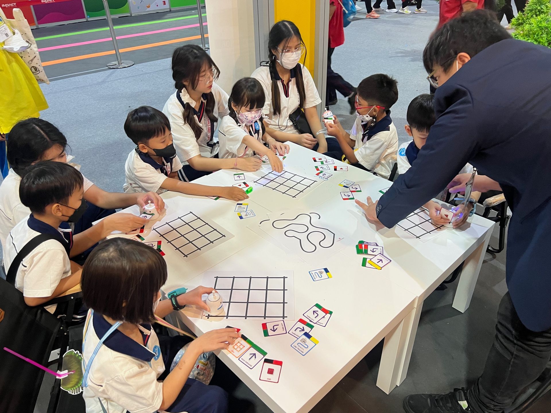 A group of children are sitting around a table playing a game.