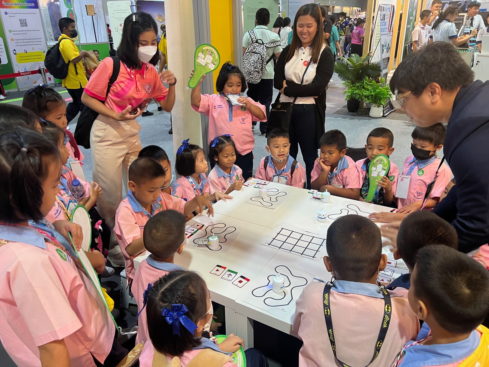 A group of children are sitting around a table playing a game.