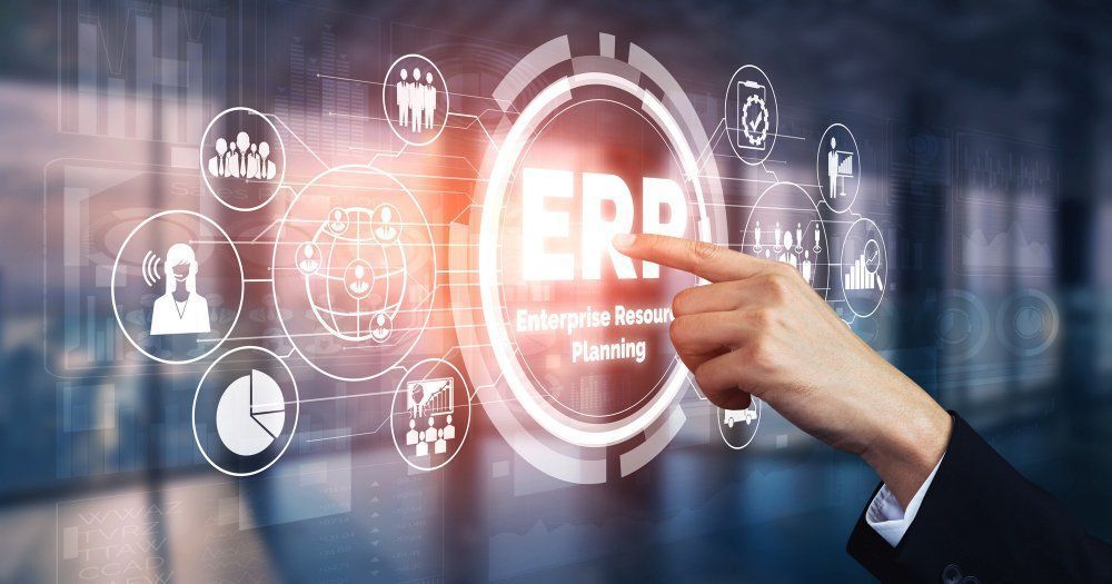 A person is pointing at a screen with the word erp on it.