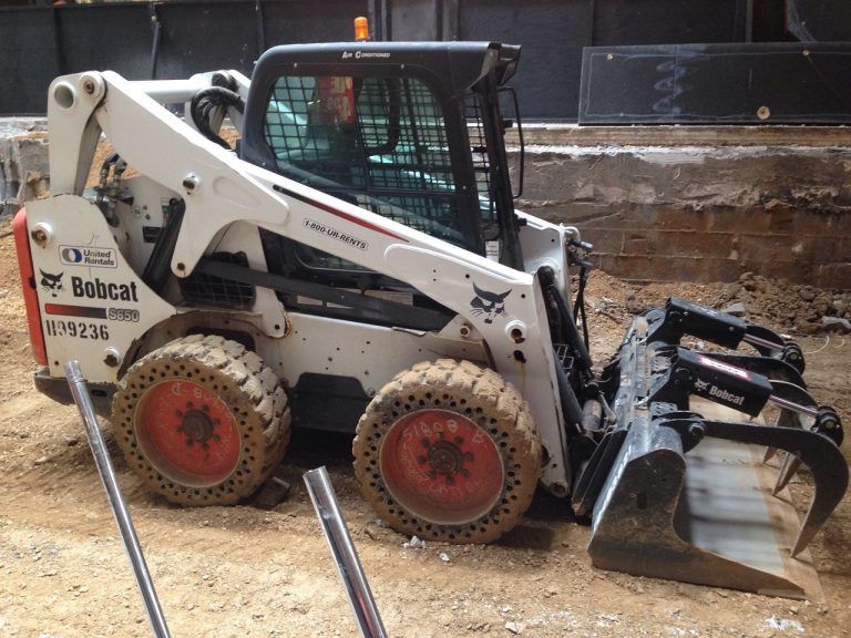 A Bobcat Skid Steer is Parked in the Dirt — Advanced Industry Training In South Townsville, QLD