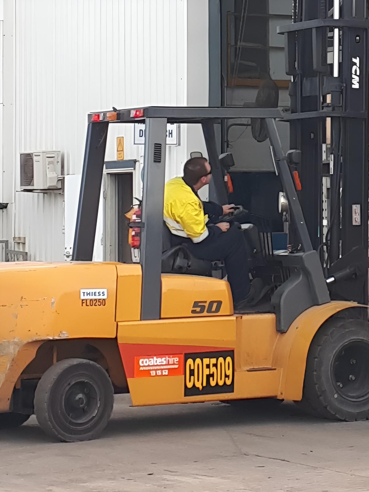 A Man is Driving a Yellow Forklift That Says Cqf509 — Advanced Industry Training In South Townsville, QLD