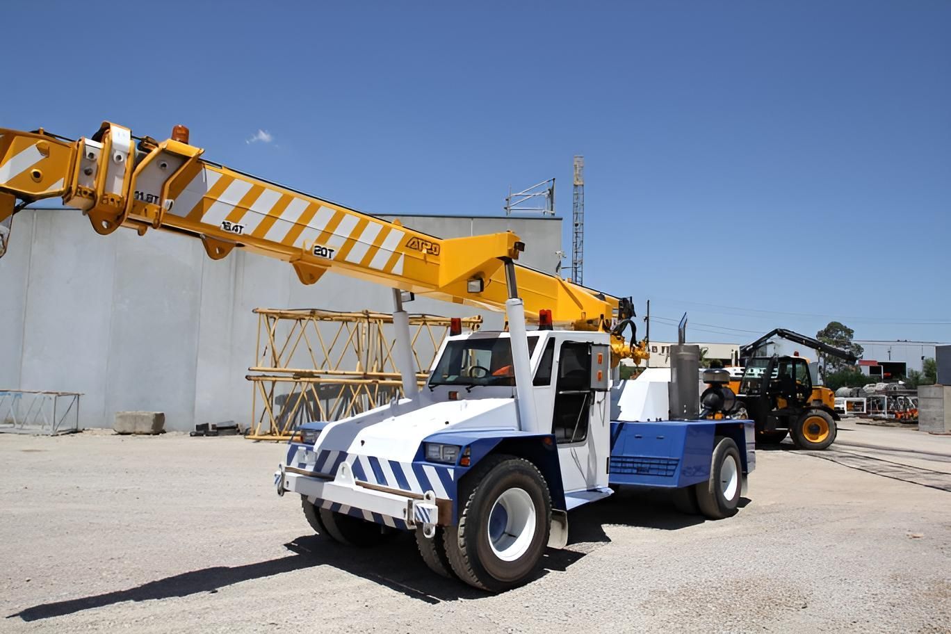 A Blue and White Truck With a Yellow Crane Attached to It — Advanced Industry Training In South Townsville, QLD