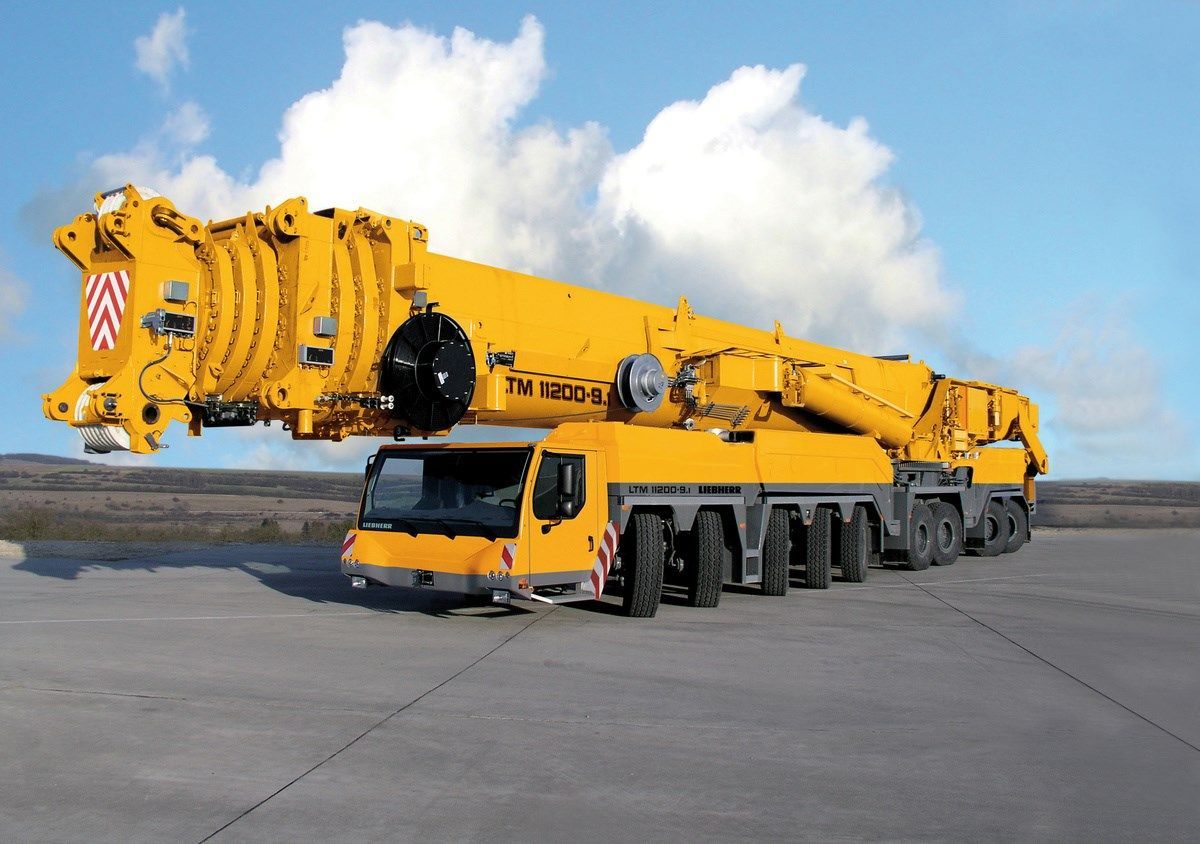 A Large Yellow Crane is Parked on the Side of the Road — Advanced Industry Training In South Townsville, QLD