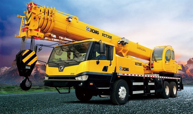 A Yellow Truck With a Crane Attached to It is Parked on a Gravel Road — Advanced Industry Training In South Townsville, QLD