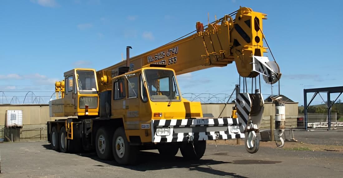 A Large Yellow Crane is Parked in a Parking Lot — Advanced Industry Training In South Townsville, QLD