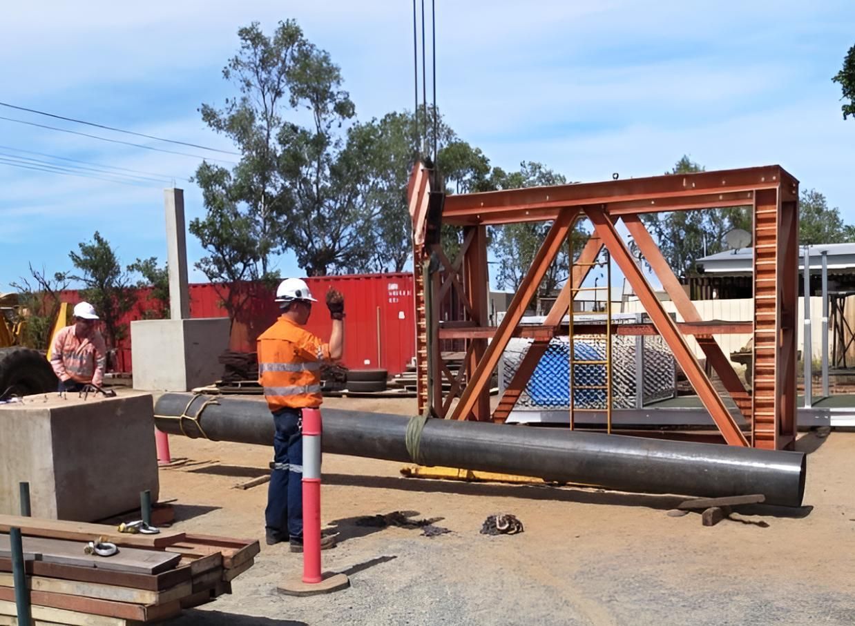 A Man in a Hard Hat is Working on a Metal Structure — Advanced Industry Training In South Townsville, QLD