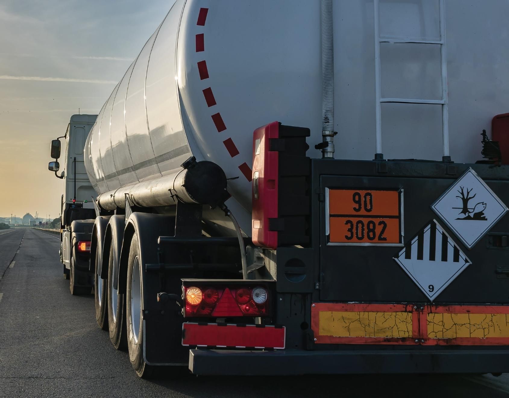 A Large Tanker Truck is Driving Down a Highway — Advanced Industry Training In South Townsville, QLD