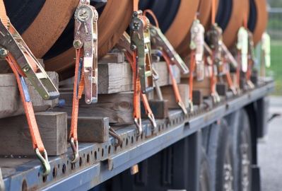 A Row of Barrels Are Sitting on the Back of a Truck — Advanced Industry Training In South Townsville, QLD