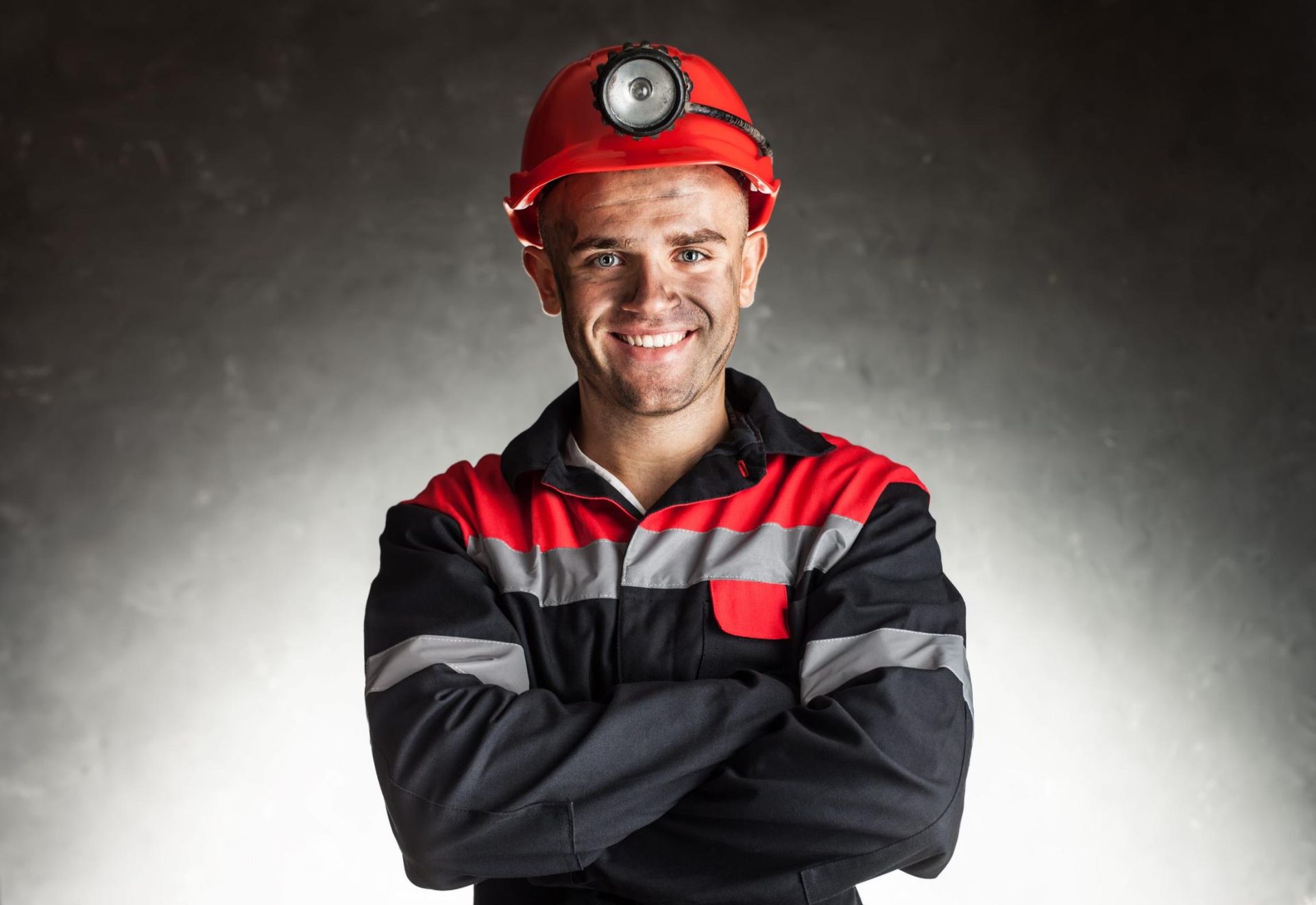 A Man is Smiling With His Arms Crossed — Advanced Industry Training In South Townsville, QLD
