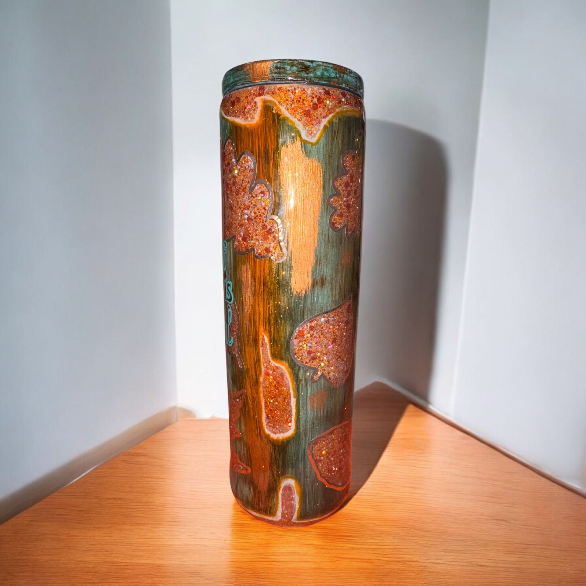 Three cylindrical tumblers with copper and teal color scheme; 