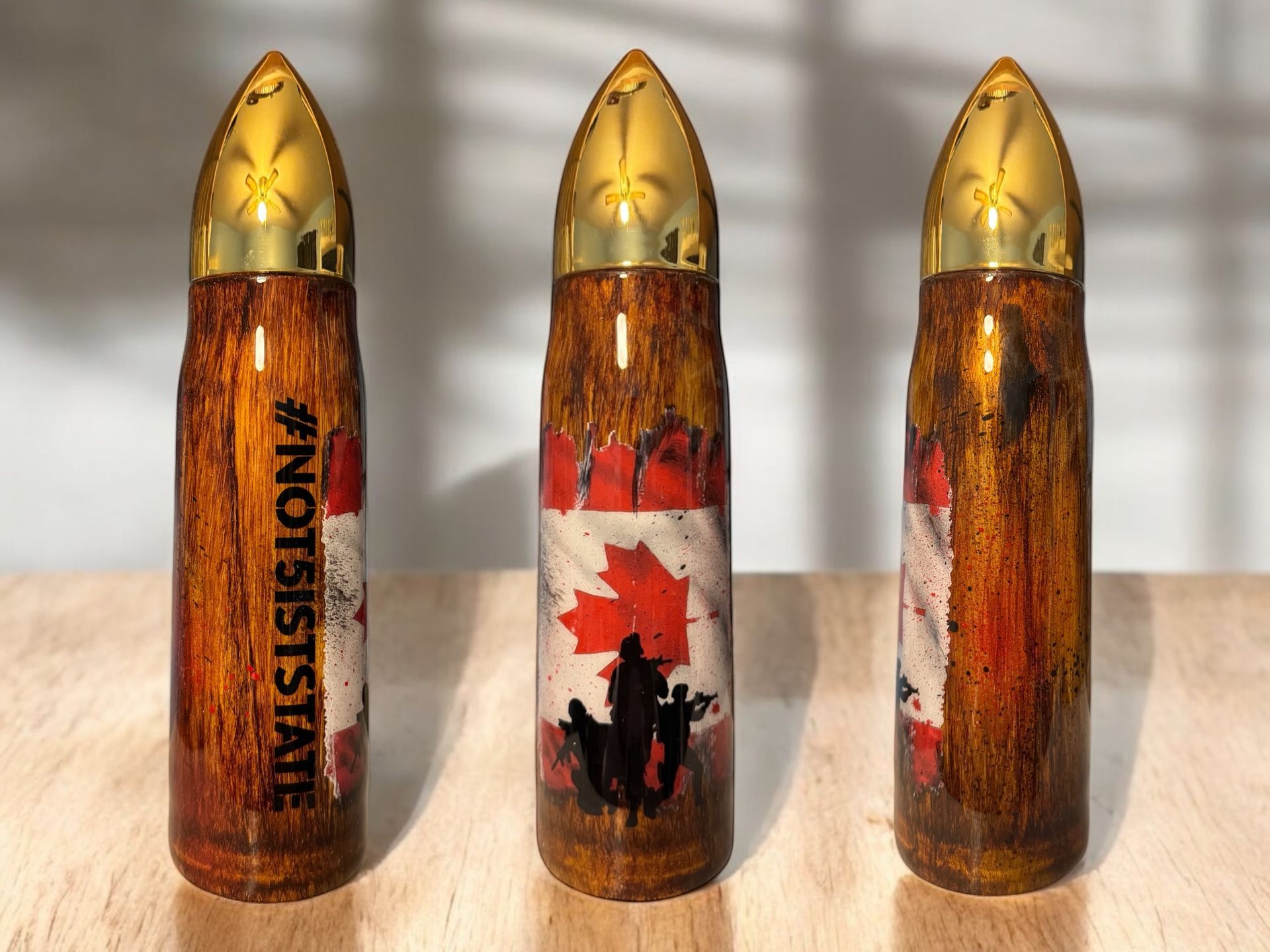 Three bullet-shaped containers with a Canadian flag design. One has 