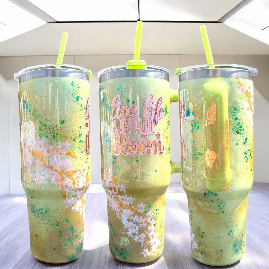Glittery green tumbler with handle, straw, and 