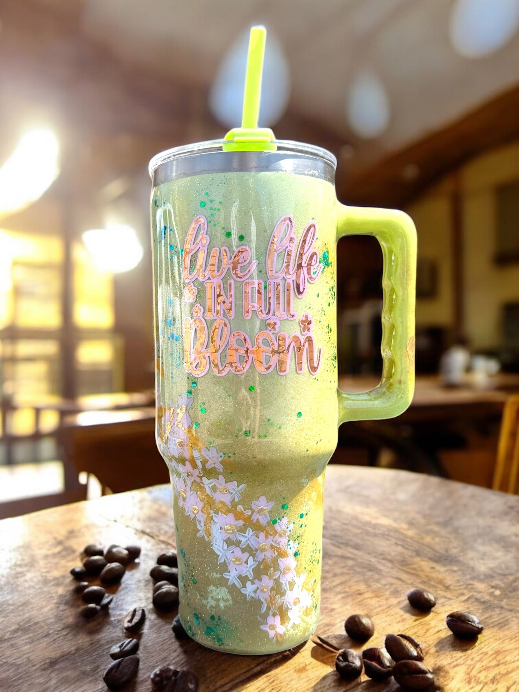 Glittery green tumbler with handle, straw, and 