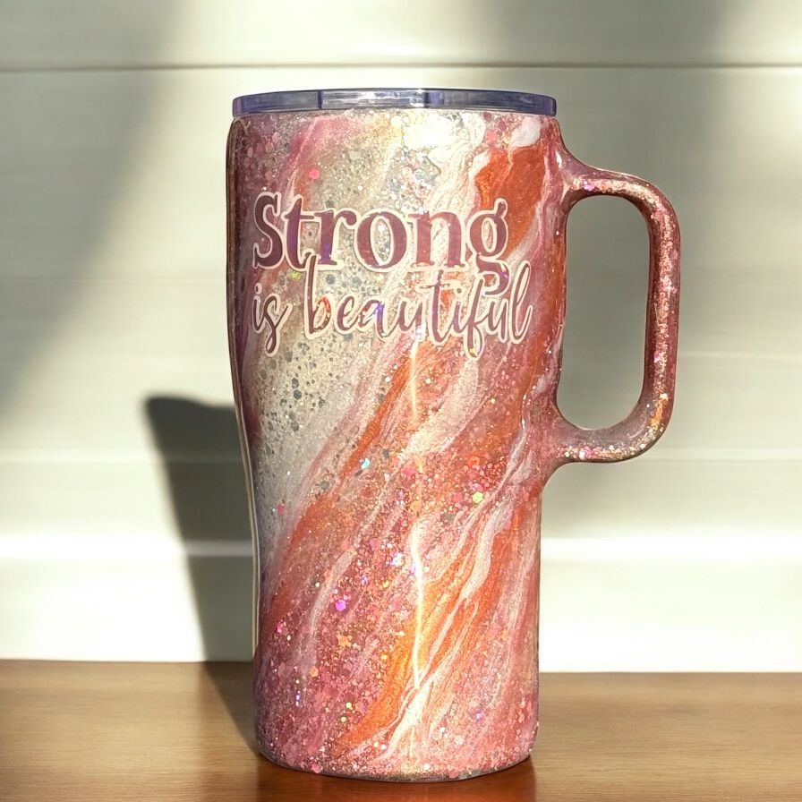 Glittery orange and white tumbler with handle, text 