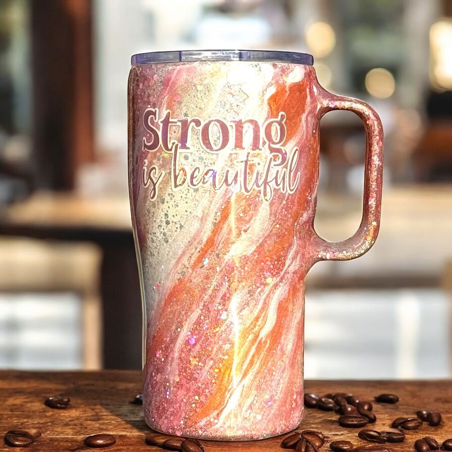 Glittery orange and white tumbler with handle, text 