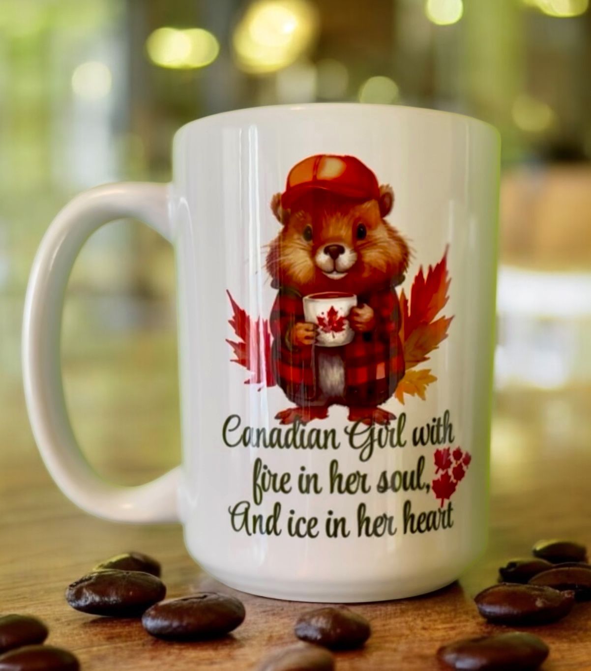 White mug with a cartoon beaver in a plaid shirt and hat, maple leaves, and the text 