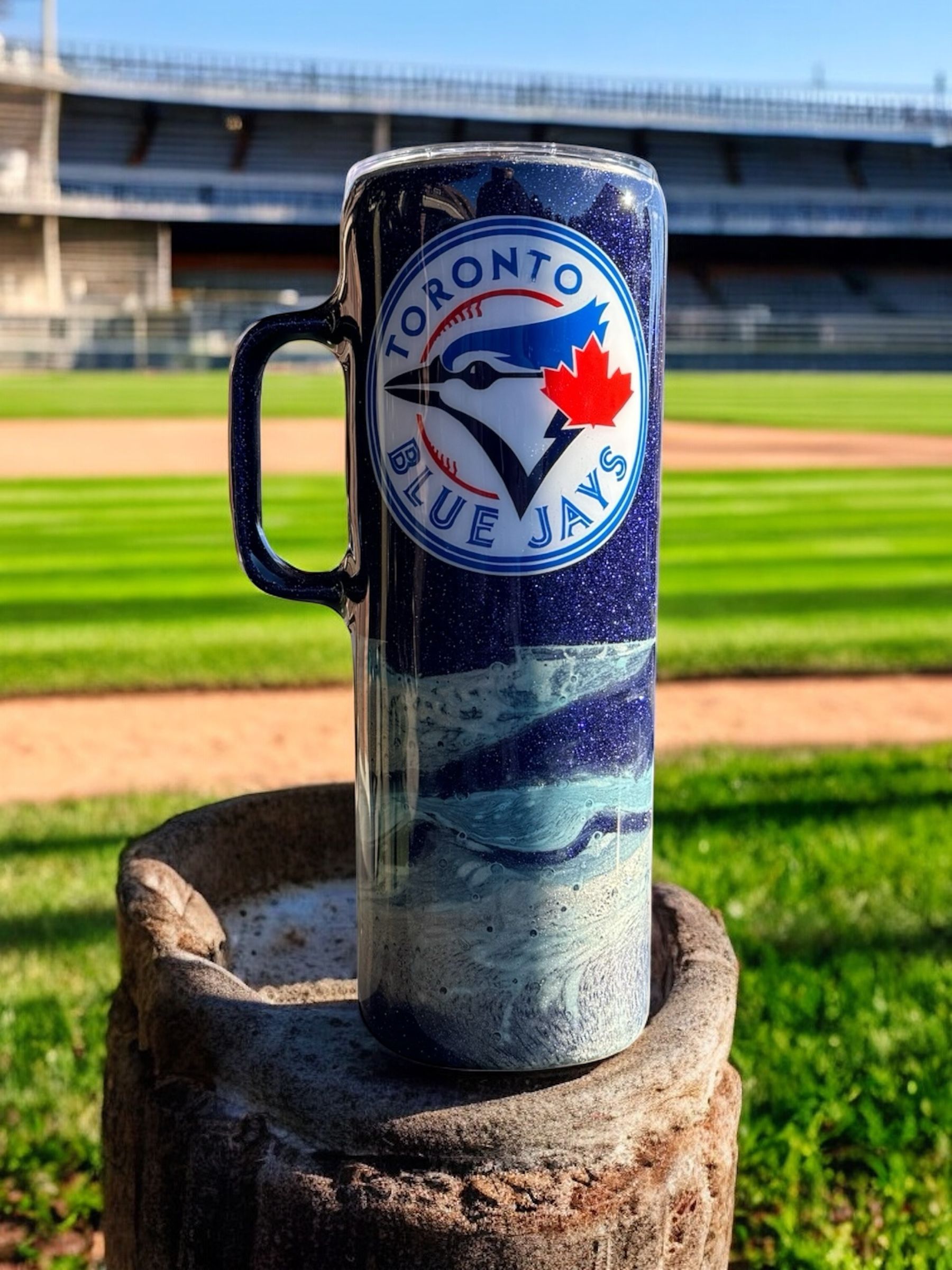 Two glittery mugs with Toronto Blue Jays logo. Blue, white, and silver colors.