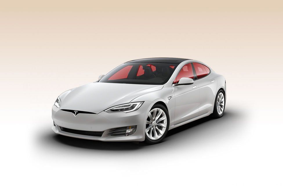 A white tesla model s is shown on a white background.