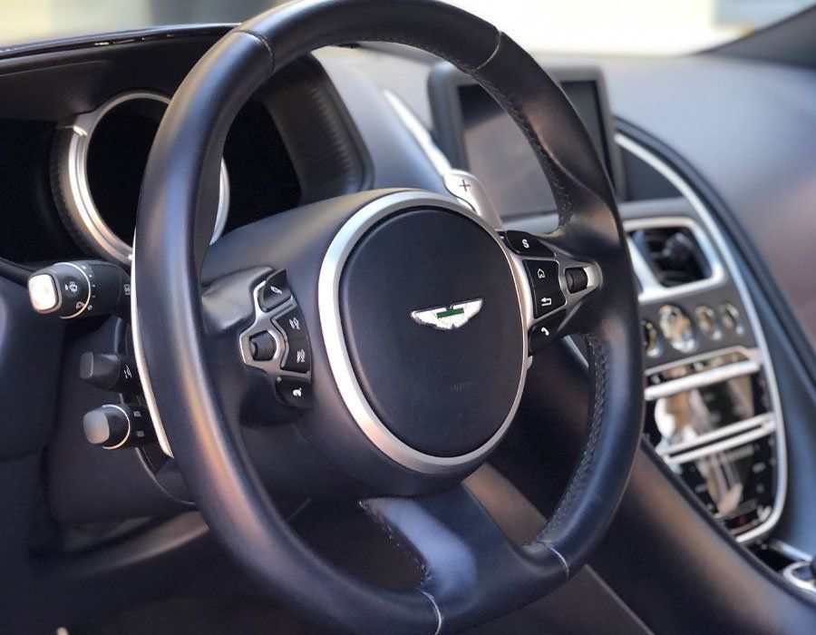 A close up of a steering wheel in a car