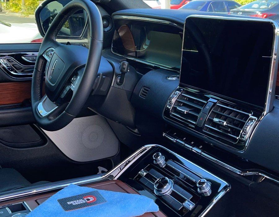 The inside of a car with a blue cloth on the dashboard.