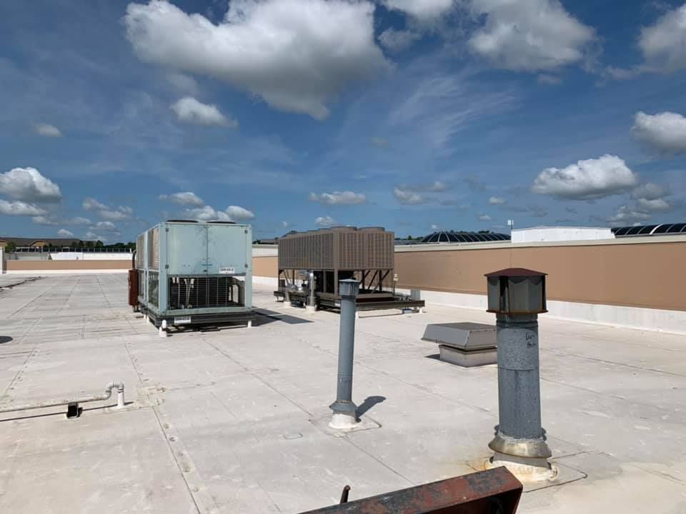 The roof of a building with a lot of air conditioning equipment on it.