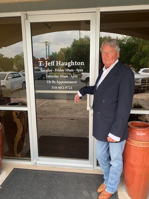 A man standing in front of a door that says jeff haughton