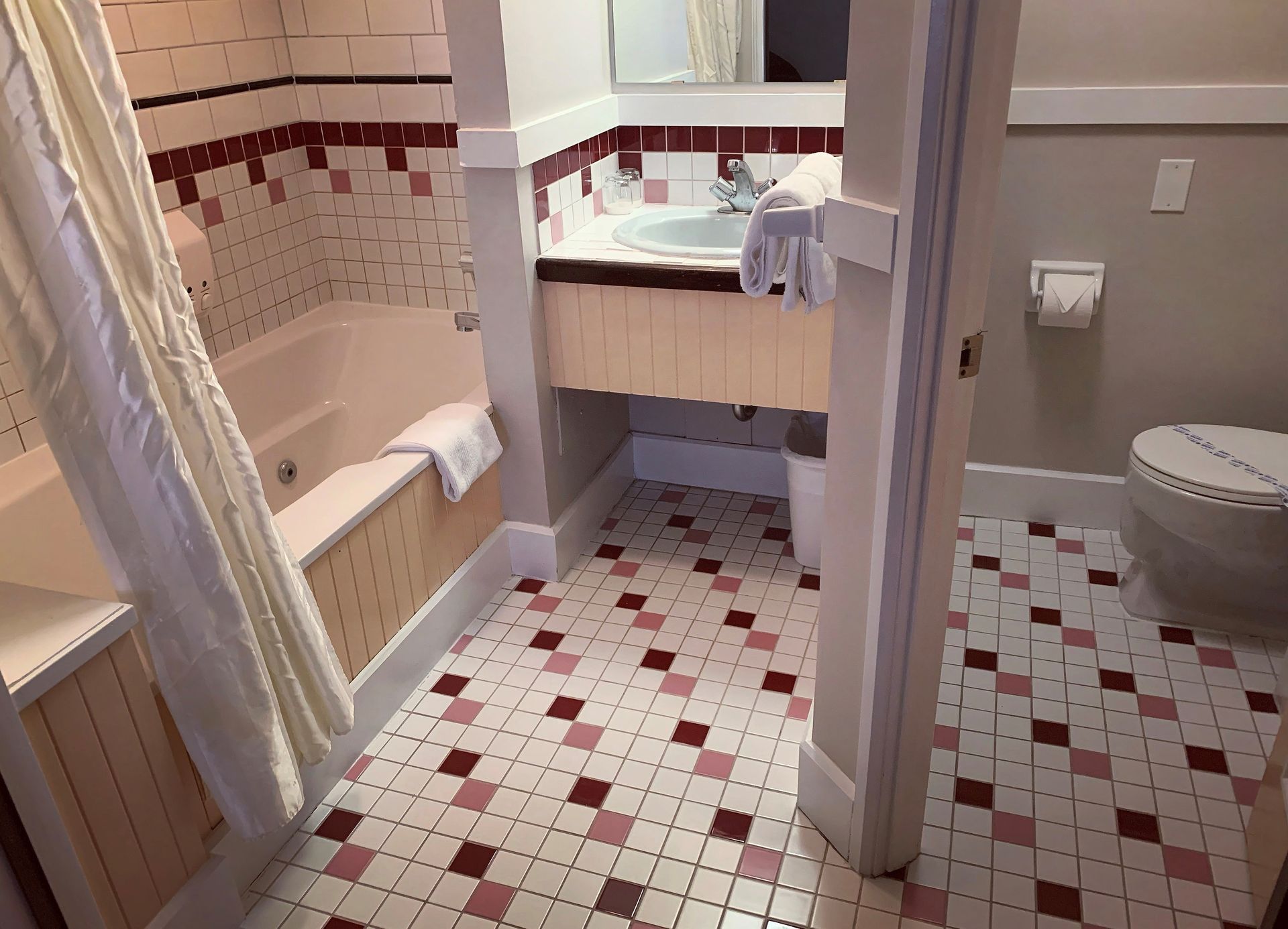 A bathroom with a bathtub a sink and a toilet