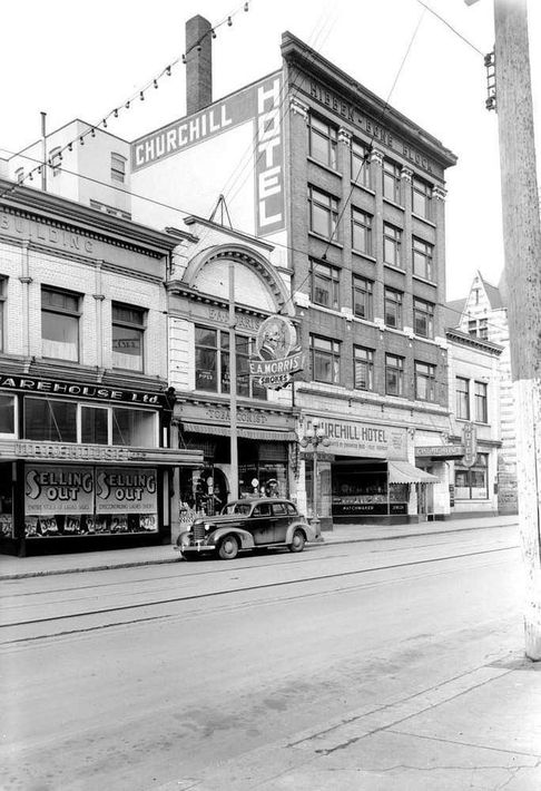 A black and white photo of the churchill hotel