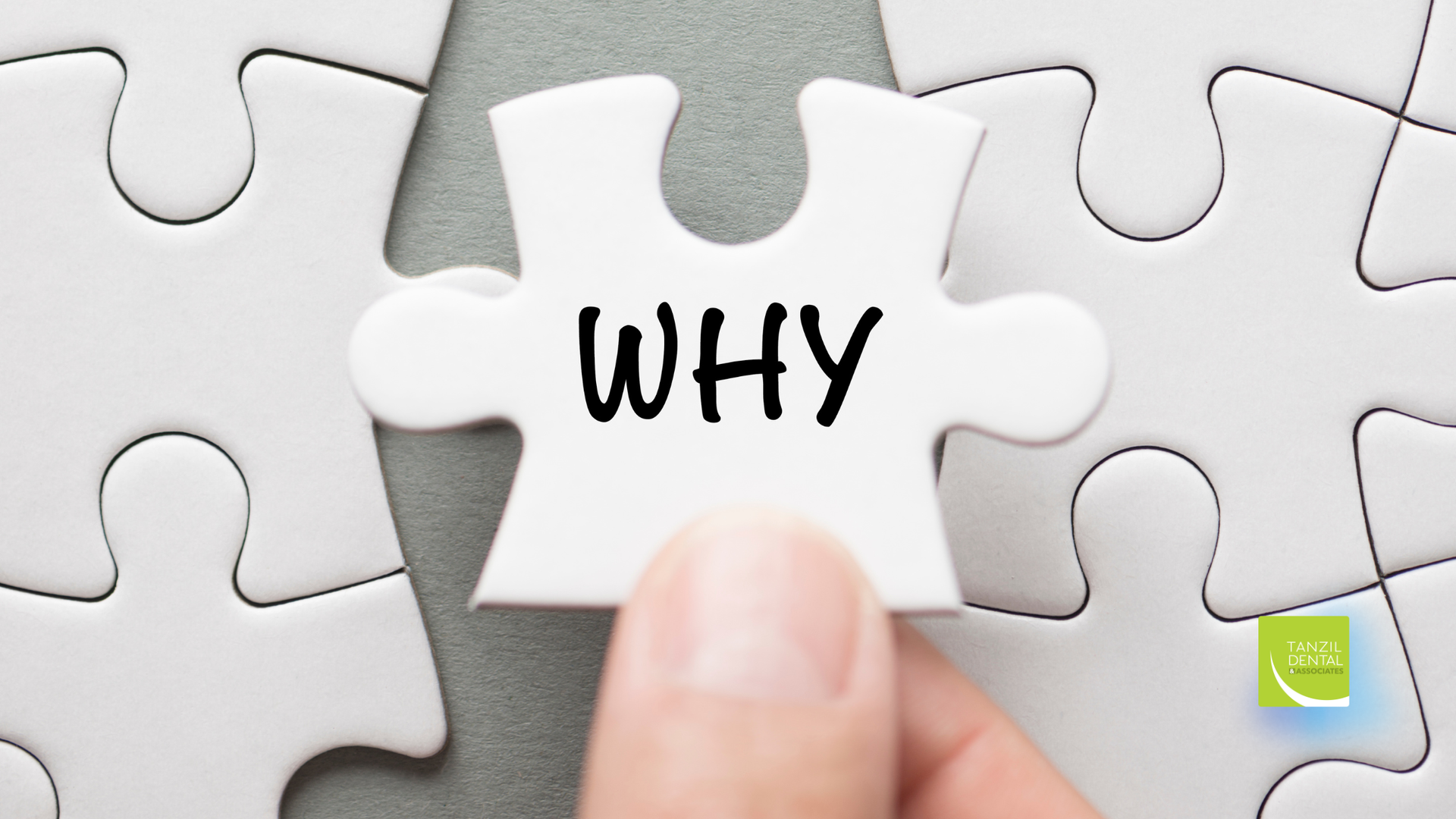 Hand holding puzzle piece with the word 