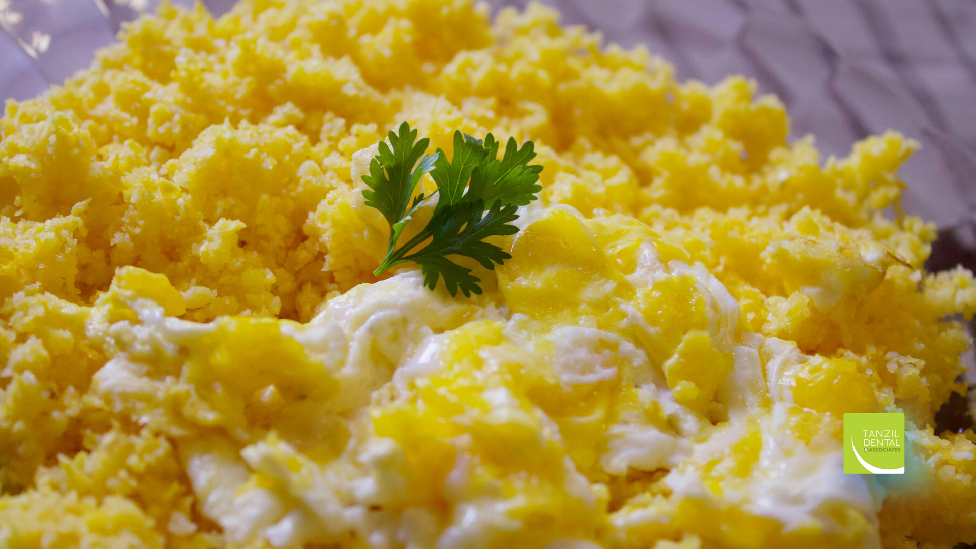 A close up of a plate of food with eggs and parsley on top.