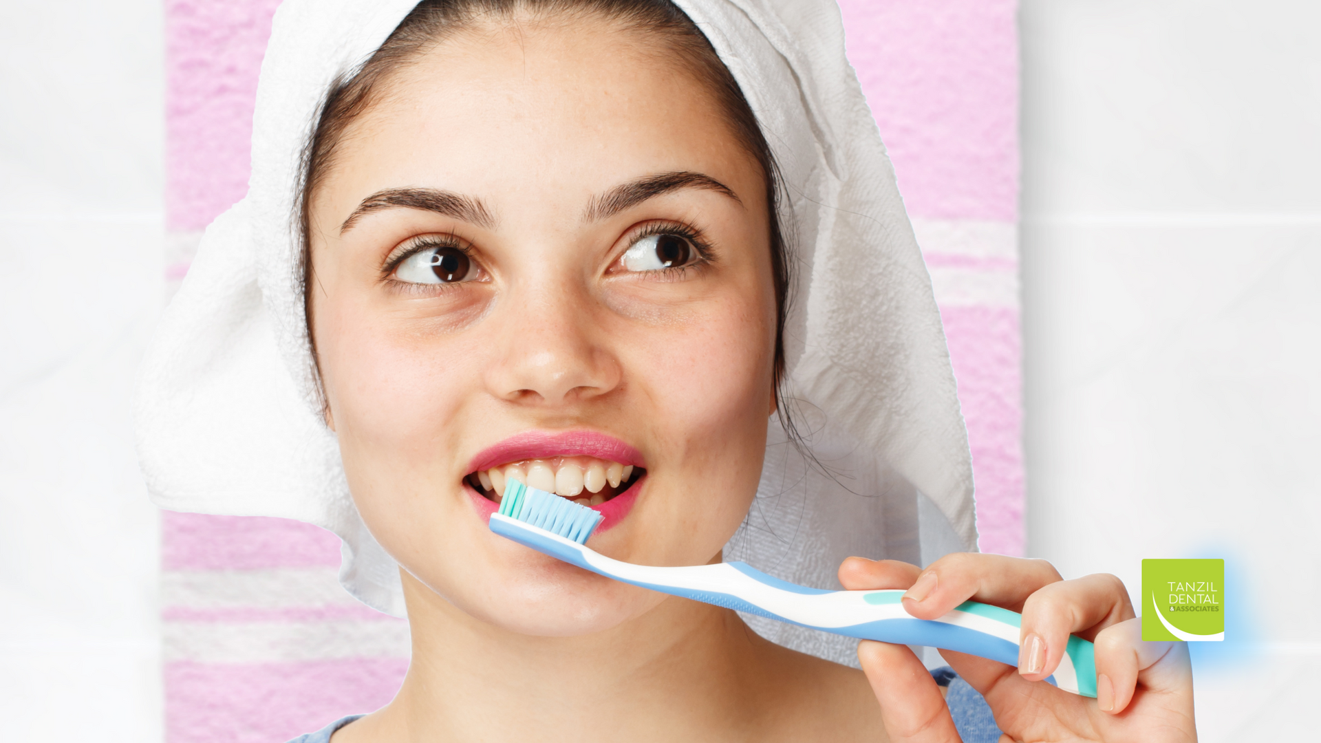 A woman with a towel wrapped around her head is brushing her teeth.
