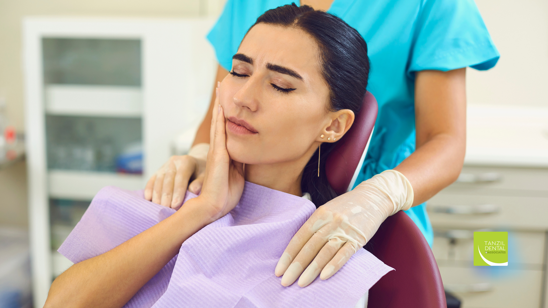 A woman is sitting in a dental chair with a toothache.
